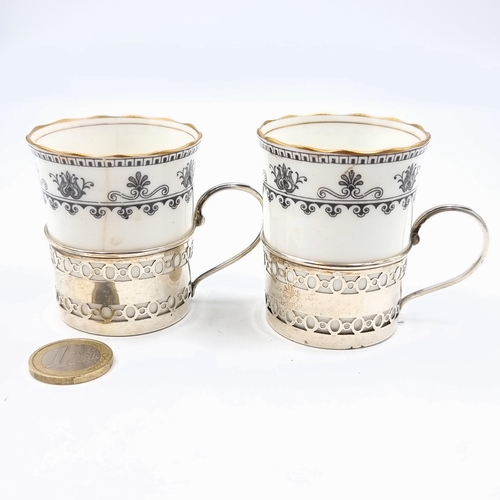 516 - A beautiful pair of Aynsley fine bone china coffee cups, set with a stunning scroll and fan border a... 