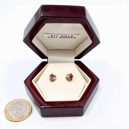 518 - A striking pair of 9 carat gold Ruby stone stud earrings. Weight: 1.05 grams. Set with butterfly bac... 