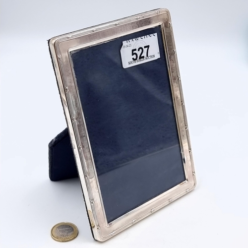 527 - An attractive example of a sterling silver glazed photo frame, set with a neat line border. Hallmark... 