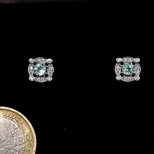 536 - A fine pair of sterling silver Green Spinel stone stud earrings, set with a lovely gem stone surroun... 