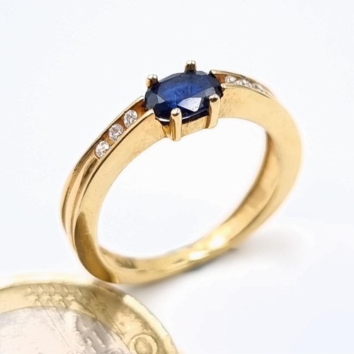 545 - Star lot : A super example of a 9 carat gold Deep Blue Sapphire and Diamond stone ring, set with a w... 