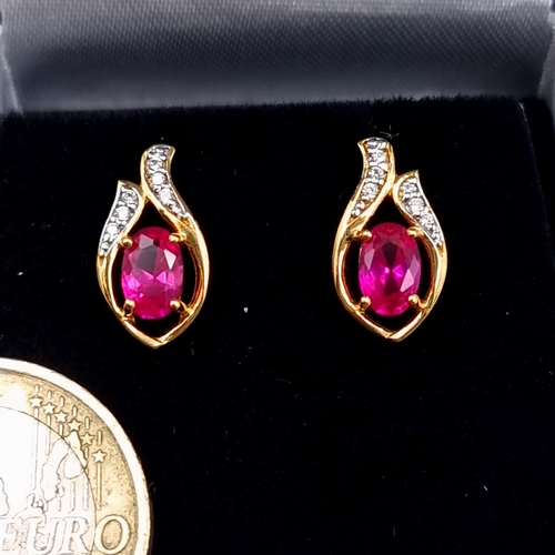 549 - A fine pair of Ruby and White Sapphire 9 carat gold plated stud earrings. Boxed, old new stock.