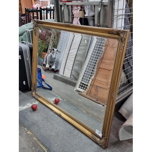 566 - Star lot : A large bevelled Over mirror housed in an elegant gilded Baroque style frame by Arquati. ... 