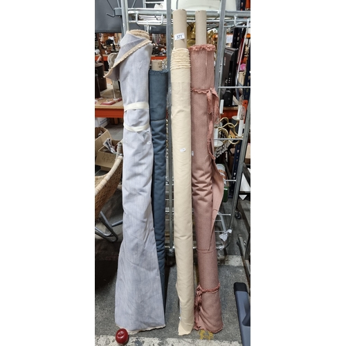 571 - Four large bolts of thick high quality fabric in shades of light red, cream, grey blue and light gre... 