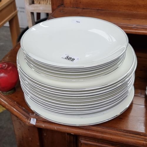 589 - A collection of nineteen Wedgewood bone china dinner plates in the Doric pattern, featuring a simple... 