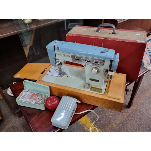 595 - A lovely vintage sewing machine in an attractive duck egg blue finish made by Brother, with original... 