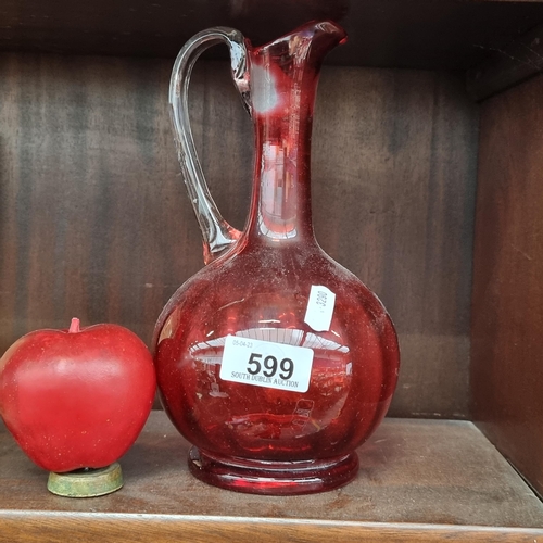 599 - A gorgeous cranberry glass round bottomed decanter with a clear glass handle.