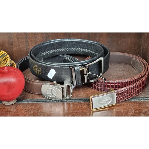 603 - Three belts including a genuine crocodile leather example in a red finish with a crocodile motif to ... 