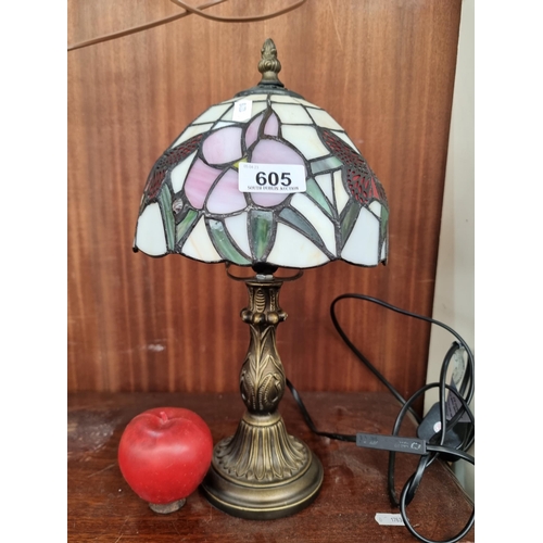 605 - A beautiful Tiffany style table lamp with ornate metal base and coloured glass shade featuring lovel... 