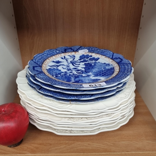 613 - Twelve plates including four blue and white side plates in the willow pattern along with eight white... 