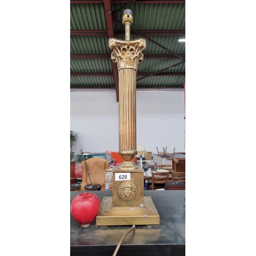 620 - A tall brass table lamp with Corinthian column and mask to pedestal base. (masks to sides are missin... 