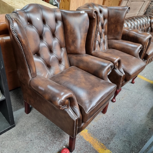 633 - Star Lot : Two super clean dark brown leather wingback Chesterfierld  armchairs with diamond button ... 