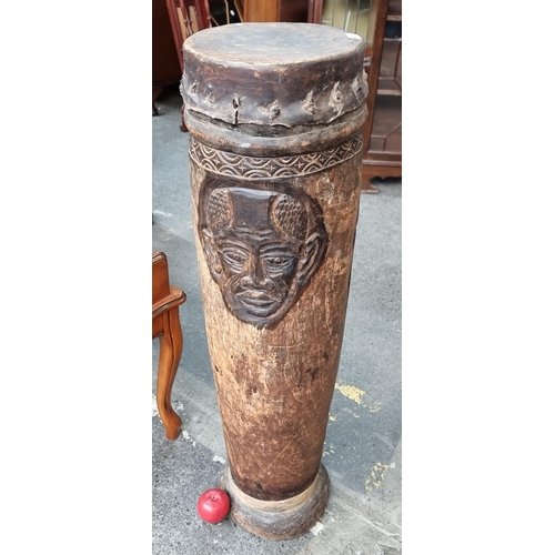 638 - Star lot : An antique large Africa friction drum with a hollow cylindrical body with animal skin str... 