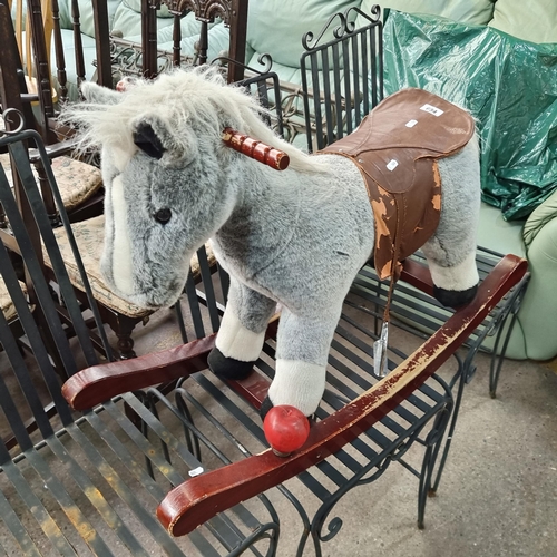 684 - A handsome Breyer rocking horse; set on a carved wooden rocker, the adorable plush grey horse has a ... 