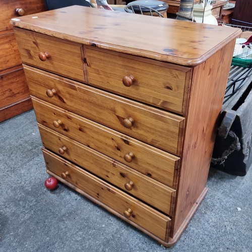 688 - A pine wood chest of six drawers. Featuring turned pine handles. In good condition. H94cm x W90cm x ... 