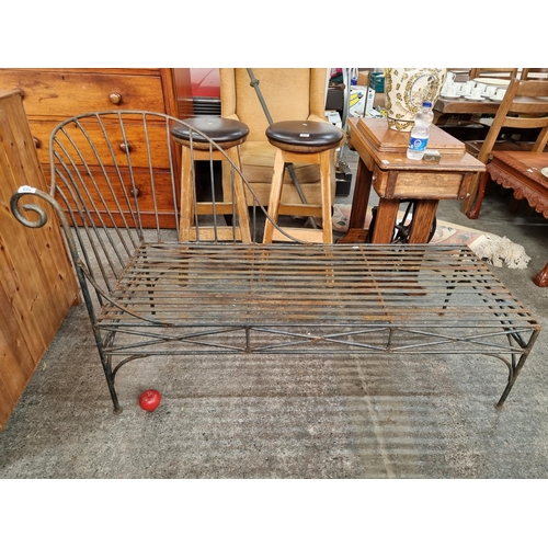 692 - A Victorian style daybed in cast metal featuring spiral and curvilinear details. Ideal for use on a ... 