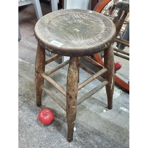 695 - A charming vintage wooden stool. A very lovely example with subtly turned dowel supports and a light... 