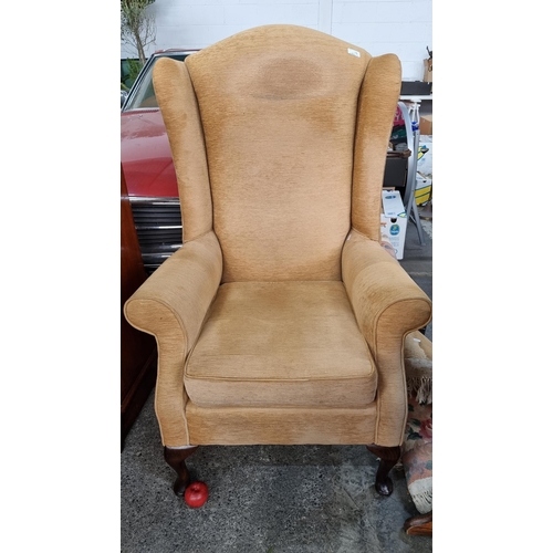 699 - A large wingback armchair in the Victorian style. Featuring a soft sand brown corduroy type upholste... 