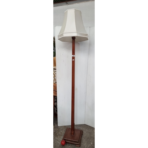 709 - A taller than average floor standing lamp. Featuring a beveled wooden square base and a square forme... 