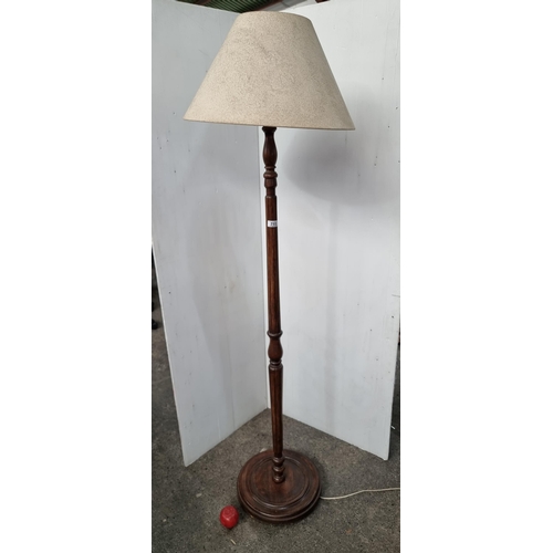 711 - A charming vintage floor standing lamp crafted from wood with turned and beveled features. Sporting ... 