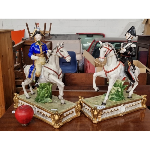 715 - Star lot : A pair of heavy porcelain cavalry figures in the Staffordshire style. Depicting both male... 