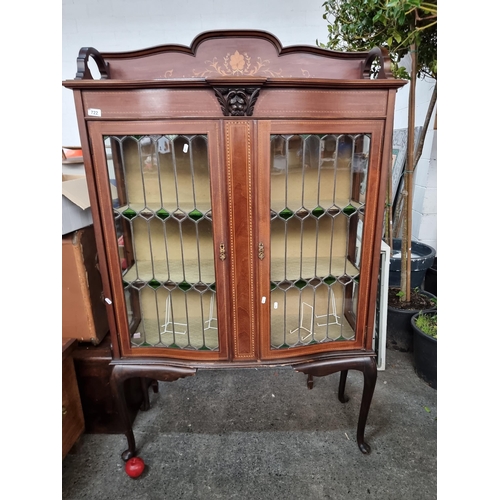 722 - Star Lot: An outstanding Victorian mahogany display cabinet. An elegant bow fronted example with an ... 