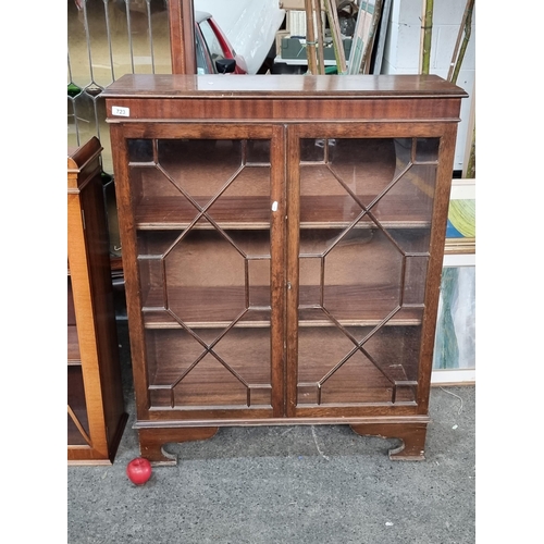 723 - A vintage astro-glazed bookcase. Featuring a pleasing geometric division of the glazed doors and two... 