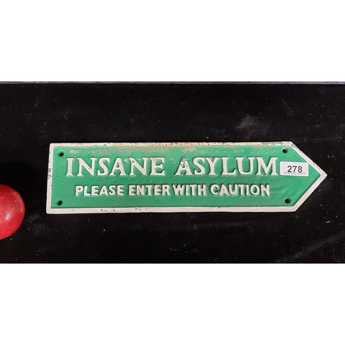 903 - A heavy cast metal finger-pointing sign reading ''Insane Asylum -Please Enter With Caution'' In gree... 