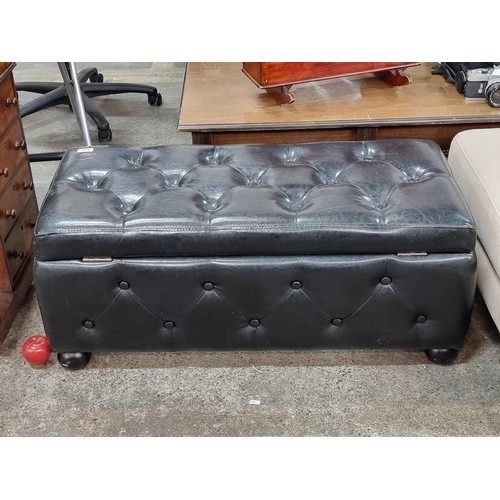 907 - A lovely Ottoman with black upholstery in the Chesterfield style. A stylish and useful storage addit... 