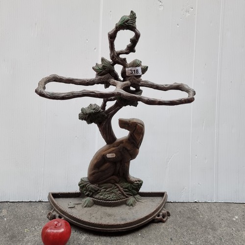 318 - A heavy high quality cast metal umbrella stand in a organic form of curving branches with a dog seat... 