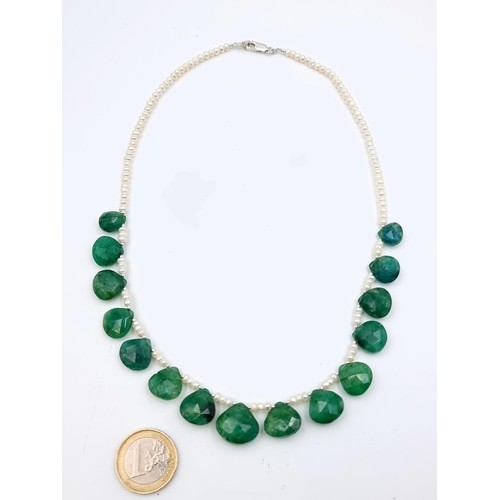 912 - Star Lot : An attractive 150 carat single strand natural pearl necklace with 15 natural emeralds all... 