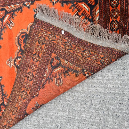 567 - Star lot : A pretty handmade, hand knotted rug in shades of red, brown and black boasting a detailed... 