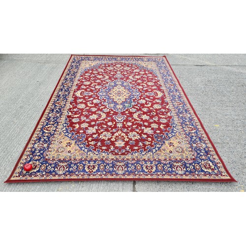 568 - Star lot : A large and beautiful rug in deep shades of maroon and navy with intricate cream detailin... 