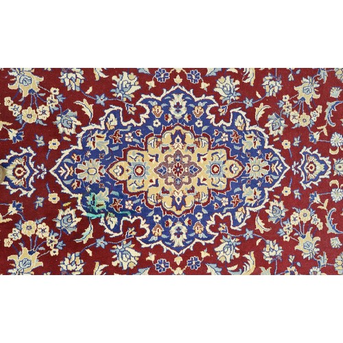 568 - Star lot : A large and beautiful rug in deep shades of maroon and navy with intricate cream detailin... 