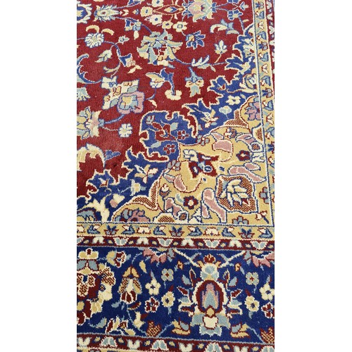 568 - Star lot : A large and beautiful rug in deep shades of maroon and navy with intricate cream detailin... 