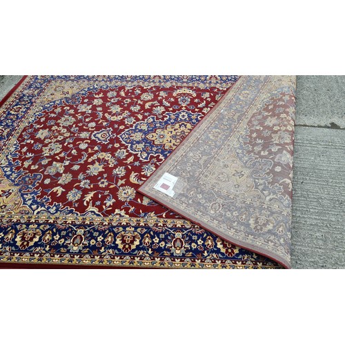 568 - Star lot : A large and beautiful rug in deep shades of maroon and navy with intricate cream detailin... 