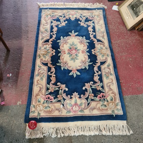 610 - A thick pile Chinese woolen hall runner rug in shades of indigo, pastel pinks, soft greens and subtl... 