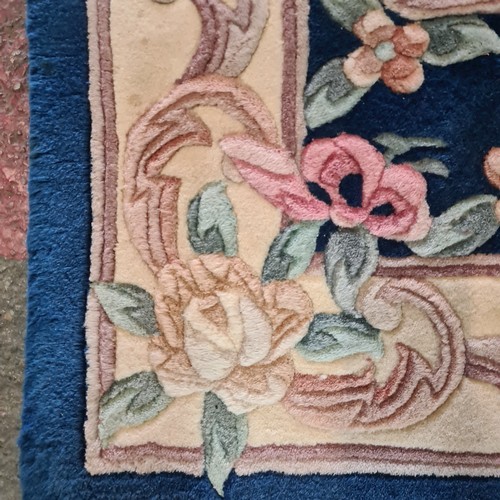 610 - A thick pile Chinese woolen hall runner rug in shades of indigo, pastel pinks, soft greens and subtl... 