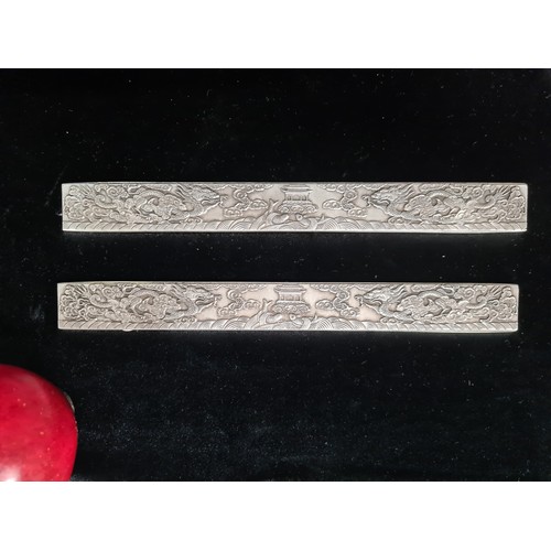 399 - Two Chinese silver bouillon bars made for scroll weight inlay. Each decorated with ornate dragon and... 