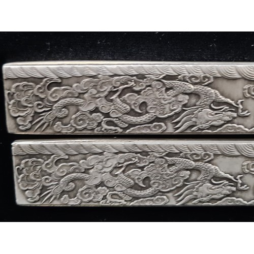 399 - Two Chinese silver bouillon bars made for scroll weight inlay. Each decorated with ornate dragon and... 