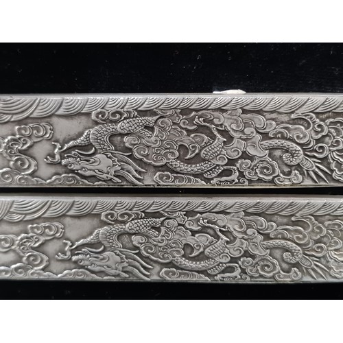 399 - Two Chinese silver bouillon bars made for scroll weight inlay. Each decorated with ornate dragon and... 