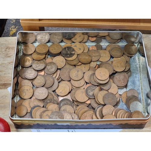 673 - A tin filled with a huge collection of Irish and British  coins.