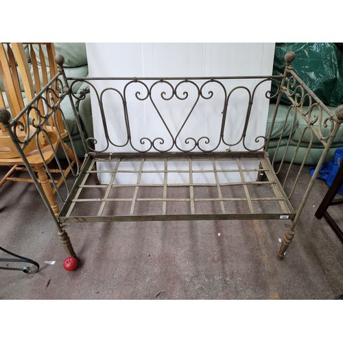 390 - A wonderful and very heavy antique wrought iron foldable day bed/bench with a drop-down base and hin... 