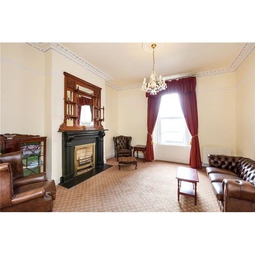 633 - Star Lot : Two super clean dark brown leather wingback Chesterfierld  armchairs with diamond button ... 