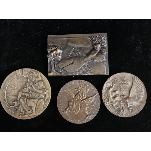 275 - A selection of four bronze and brass tokens. These are large vintage examples. Including a solid bro... 