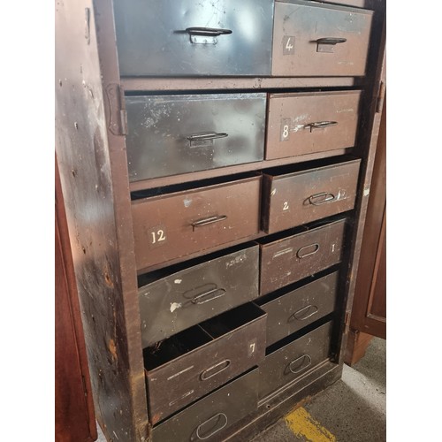 551 - An industrial storage cabinet with shelving space to top and twelve deep pull out drawers to base. I... 