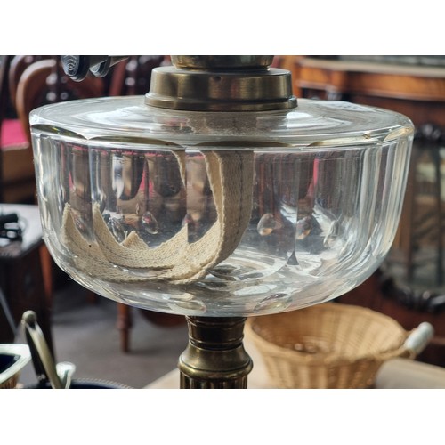 581 - Star lot : A very impressive antique oil lamp with a brass reeded column base, a clear reservoir, a ... 