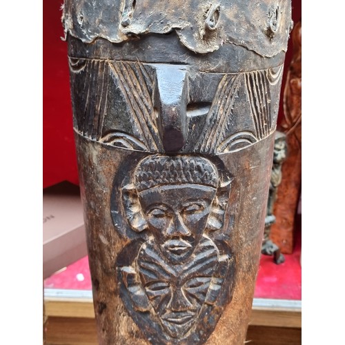 637 - Star lot : An antique large Africa friction drum with a hollow cylindrical body with animal skin str... 