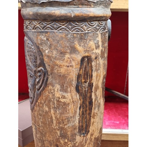 638 - Star lot : An antique large Africa friction drum with a hollow cylindrical body with animal skin str... 