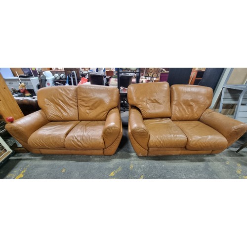 657 - Star lot : A pair of very comfortable two seater leather sofas, with a wonderful curved frame and up... 